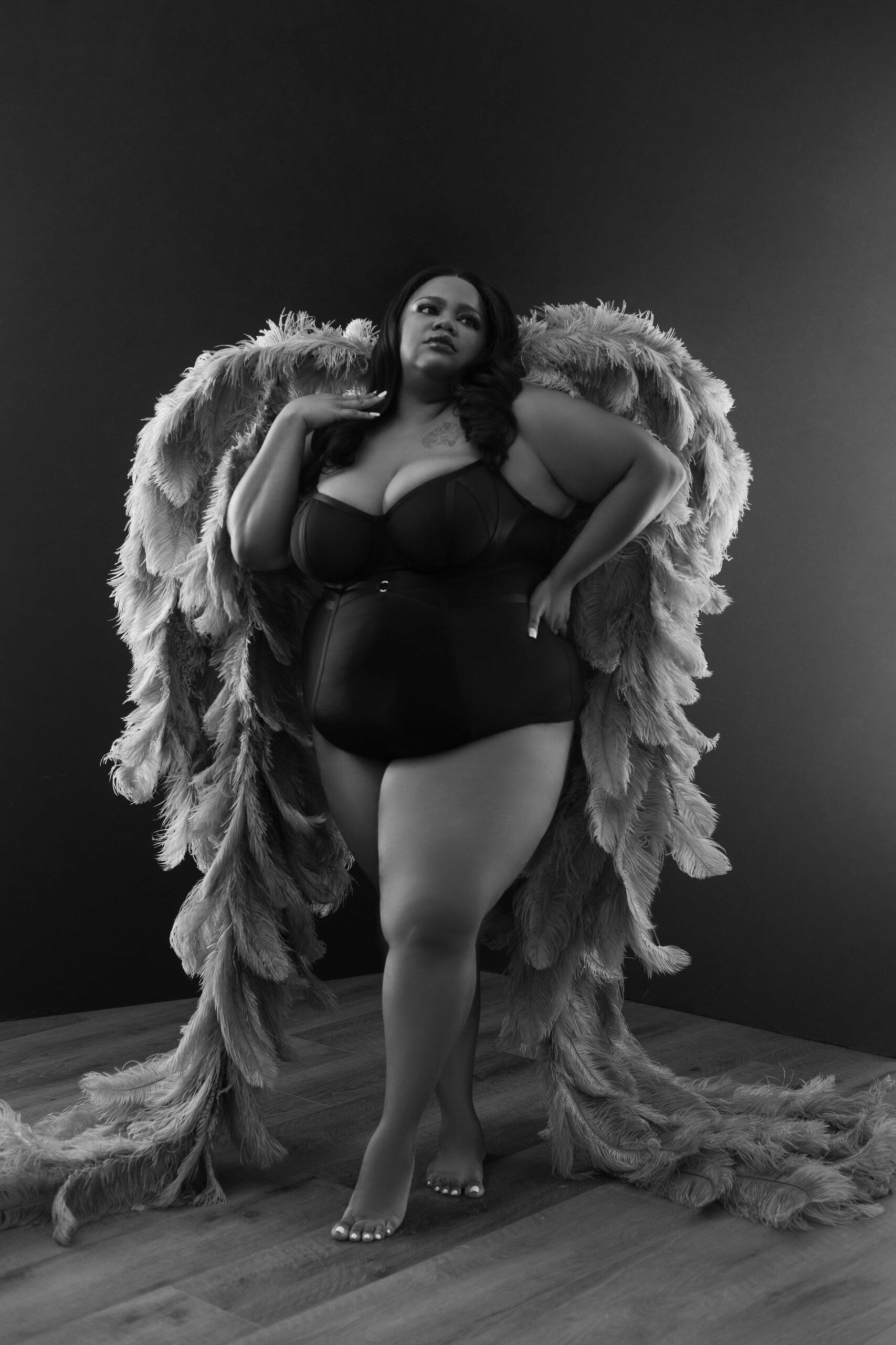 'Celebrate Your Beauty: A woman with wings in a powerful and artistic photograph.