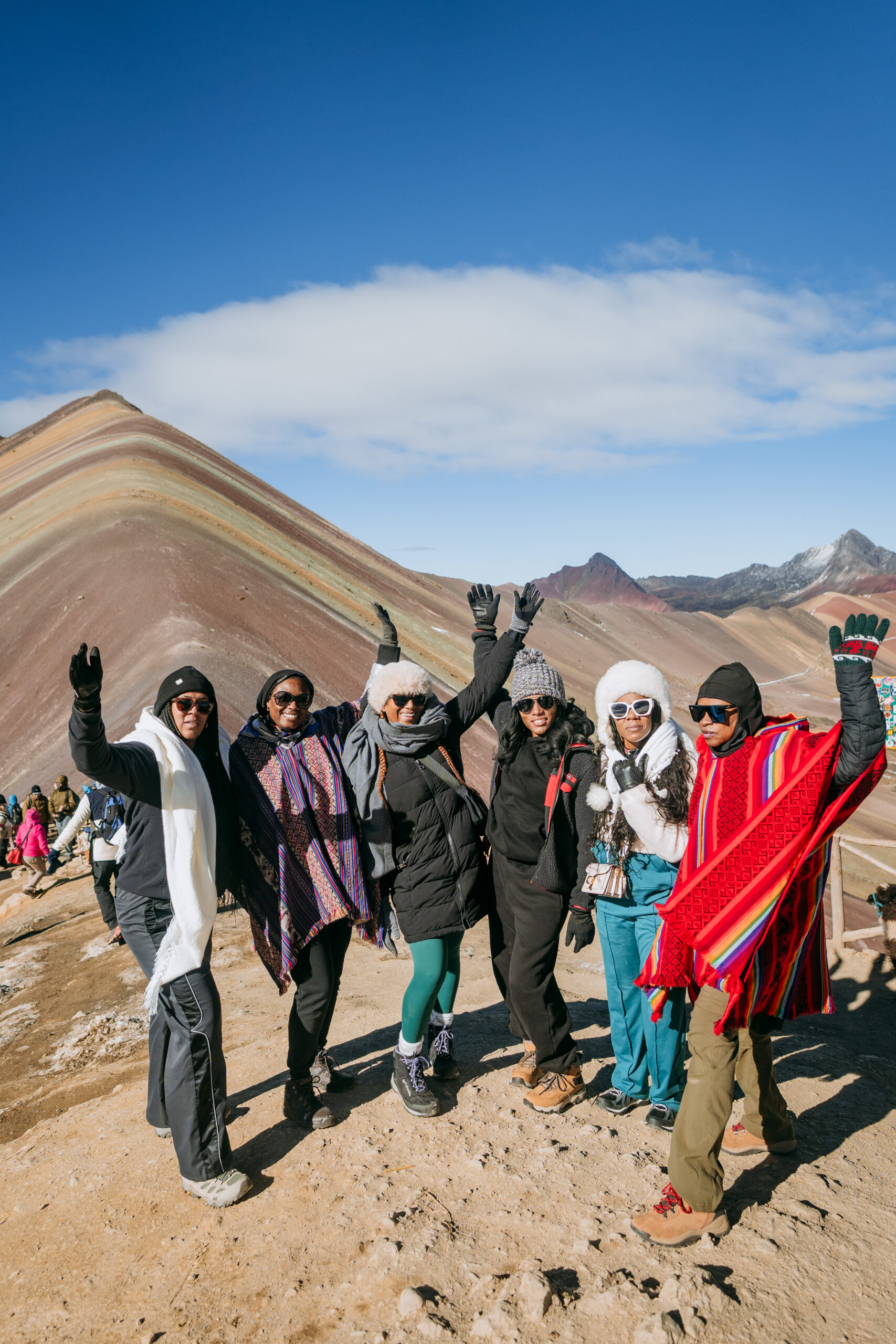 Why Traveling to Peru Was One of the Best Investments I’ve Made in Myself | Group of my travel besties in peru at Rainbow Mountain scaled