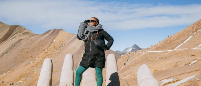 Rainbow Mountain Hand in Peru Why Traveling to Peru Was One of the Best Investments I’ve Made in Myself | Rainbow Mountain Hand in Peru scaled