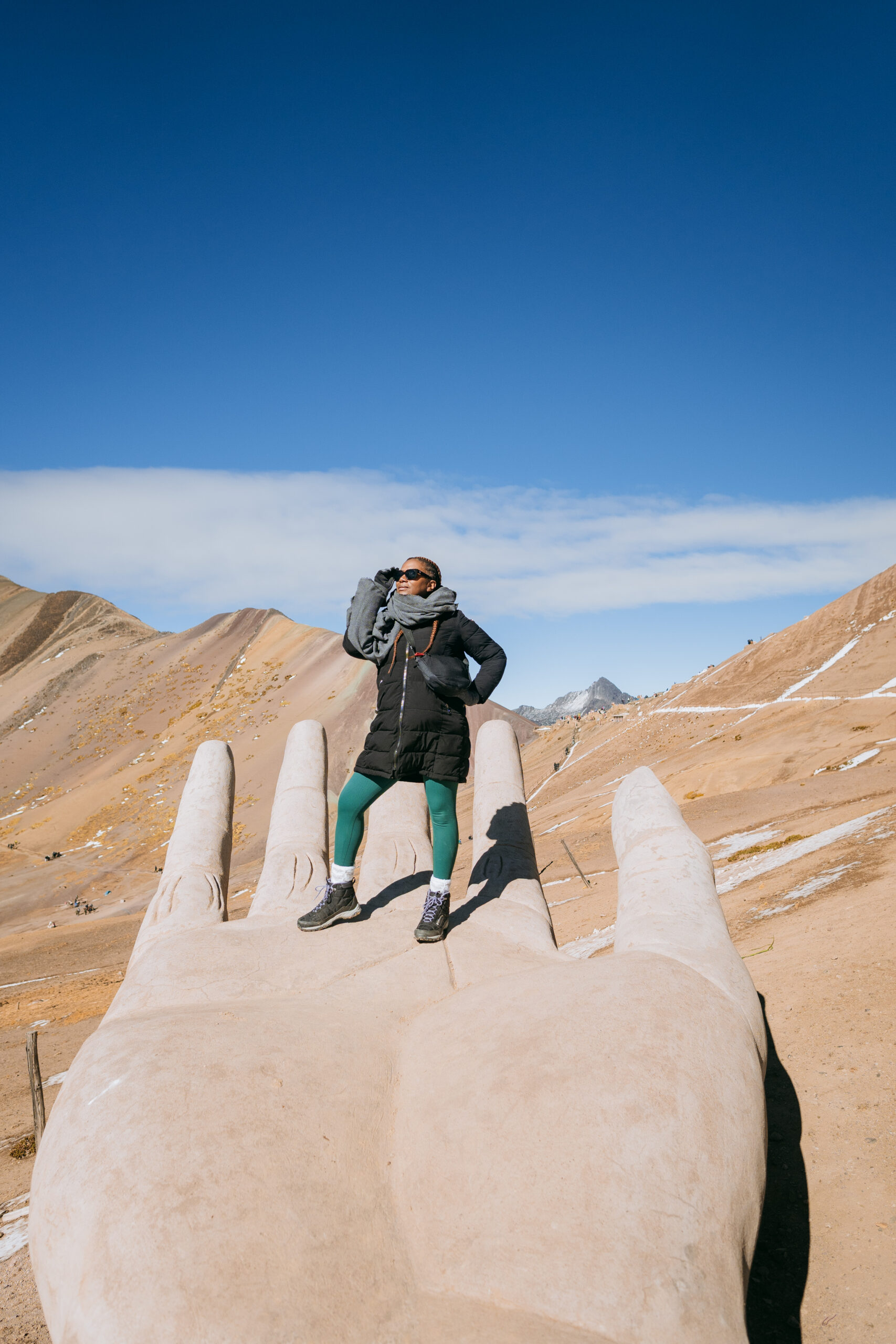 Why Traveling to Peru Was One of the Best Investments I’ve Made in Myself | Rainbow Mountain Hand in Peru scaled
